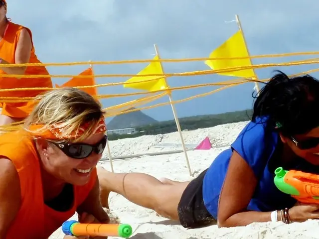 Participantes con pistolas de agua en la playa